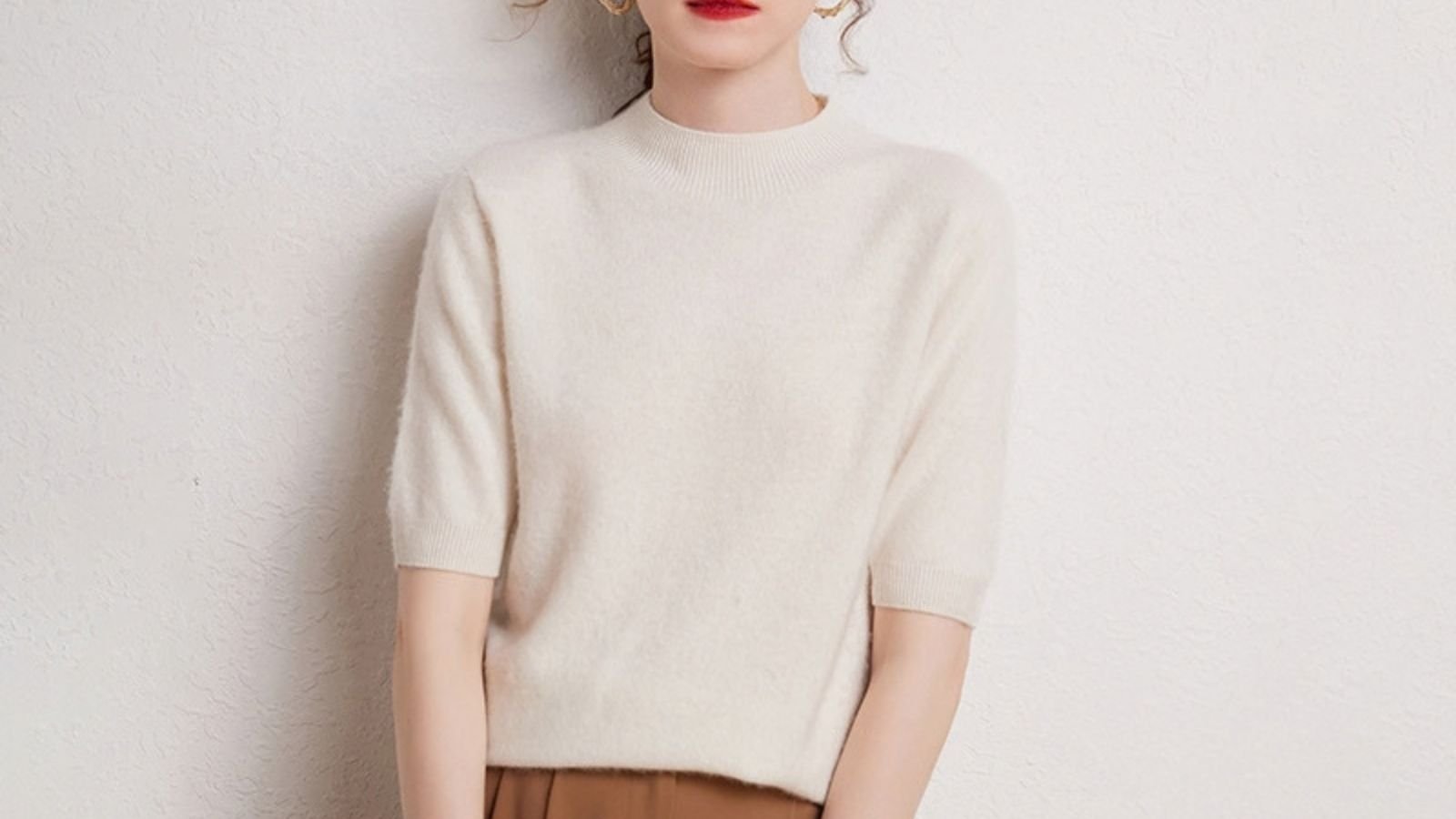 Woman wearing a lightweight white cashmere top in mild weather